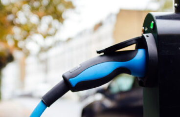 A plug in tank cap used for charging and refuelling of an electric car at an electric station