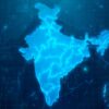 Digital map of India illuminated in blue tones, featuring a futuristic design that simulates a technological interface and data patterns in the background. India